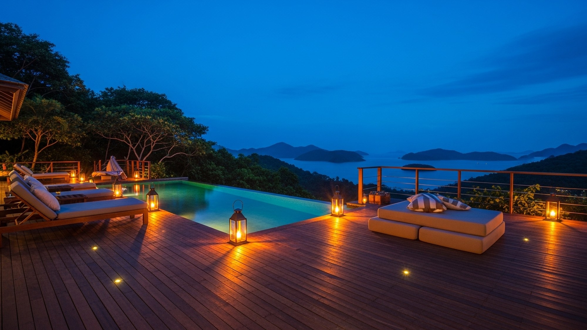 Amorielli deck at dusk, lanterns lit, forest and bay beyond