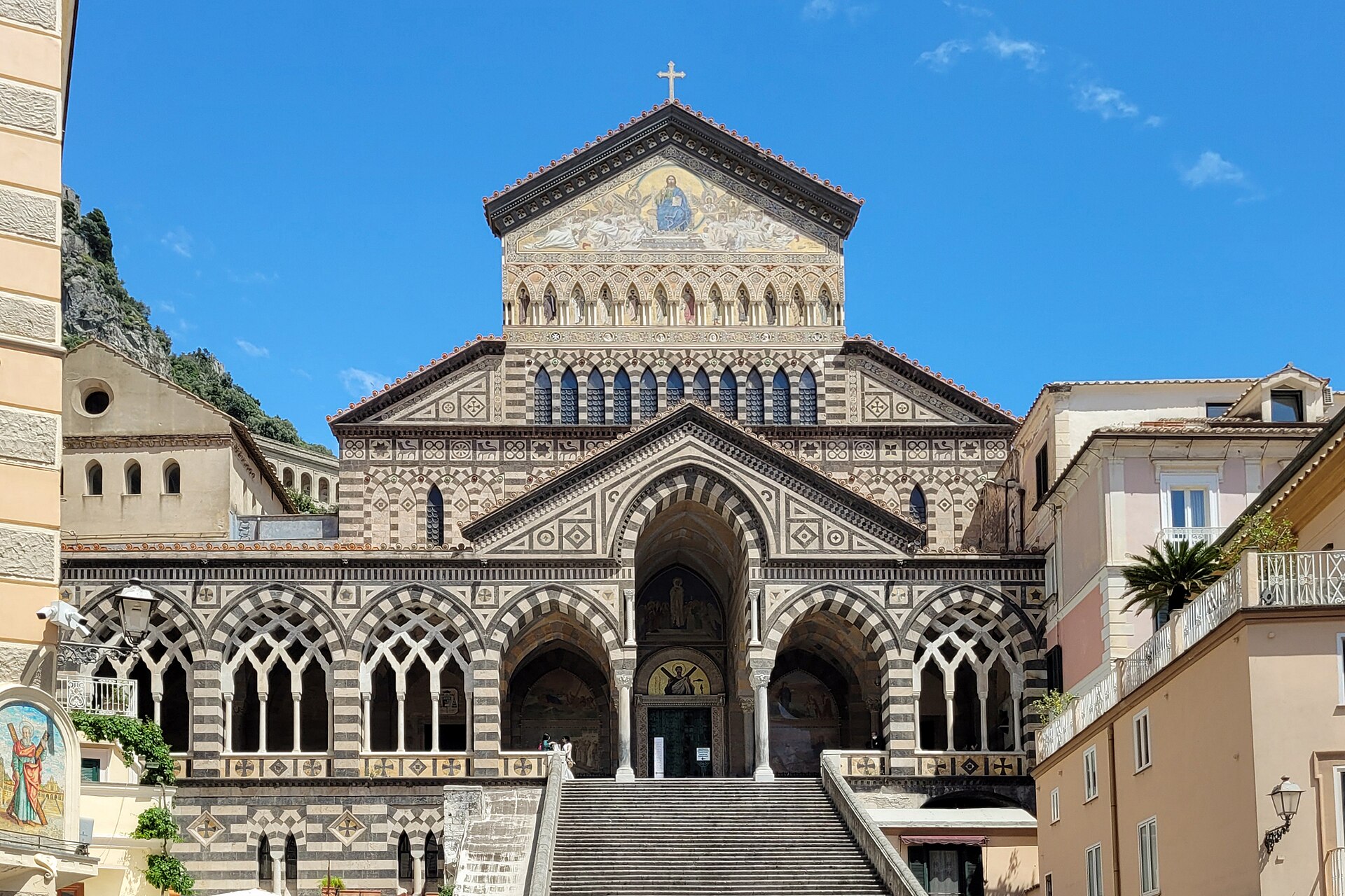 The striped facade and wide staircase of Amalfi Cathedral rising above the town square