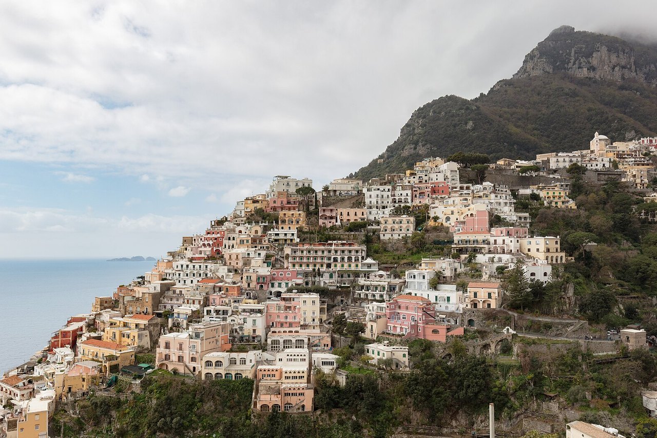 Positano's pastel houses rising in tiers up the cliffs above the beach on the Amalfi Coast
