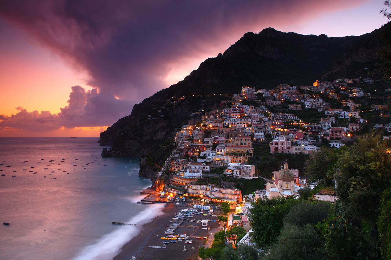 Positano's pastel houses rising in tiers up the cliffs above the beach on the Amalfi Coast