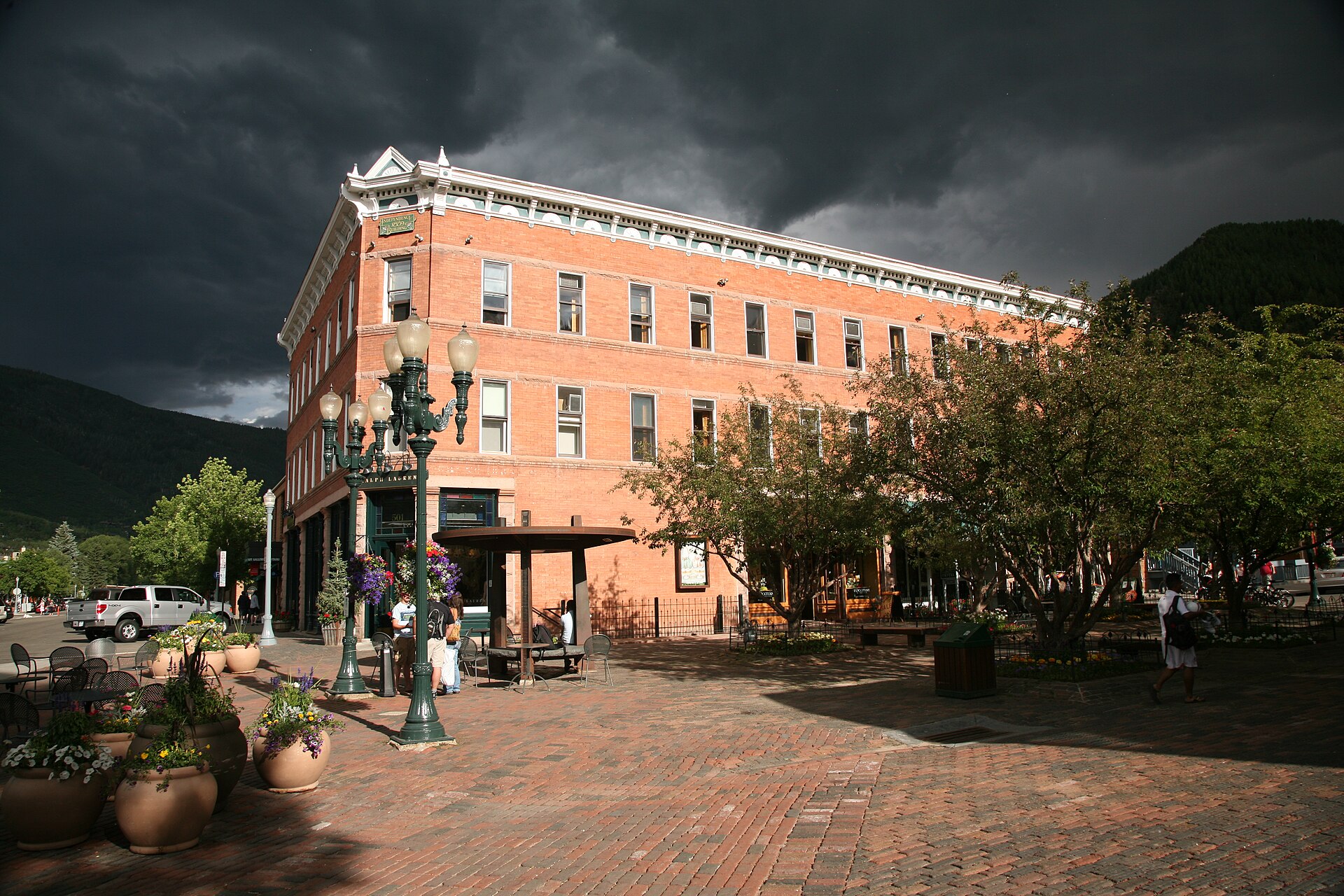 Downtown Aspen in winter, Victorian storefronts under snow with Aspen Mountain rising behind