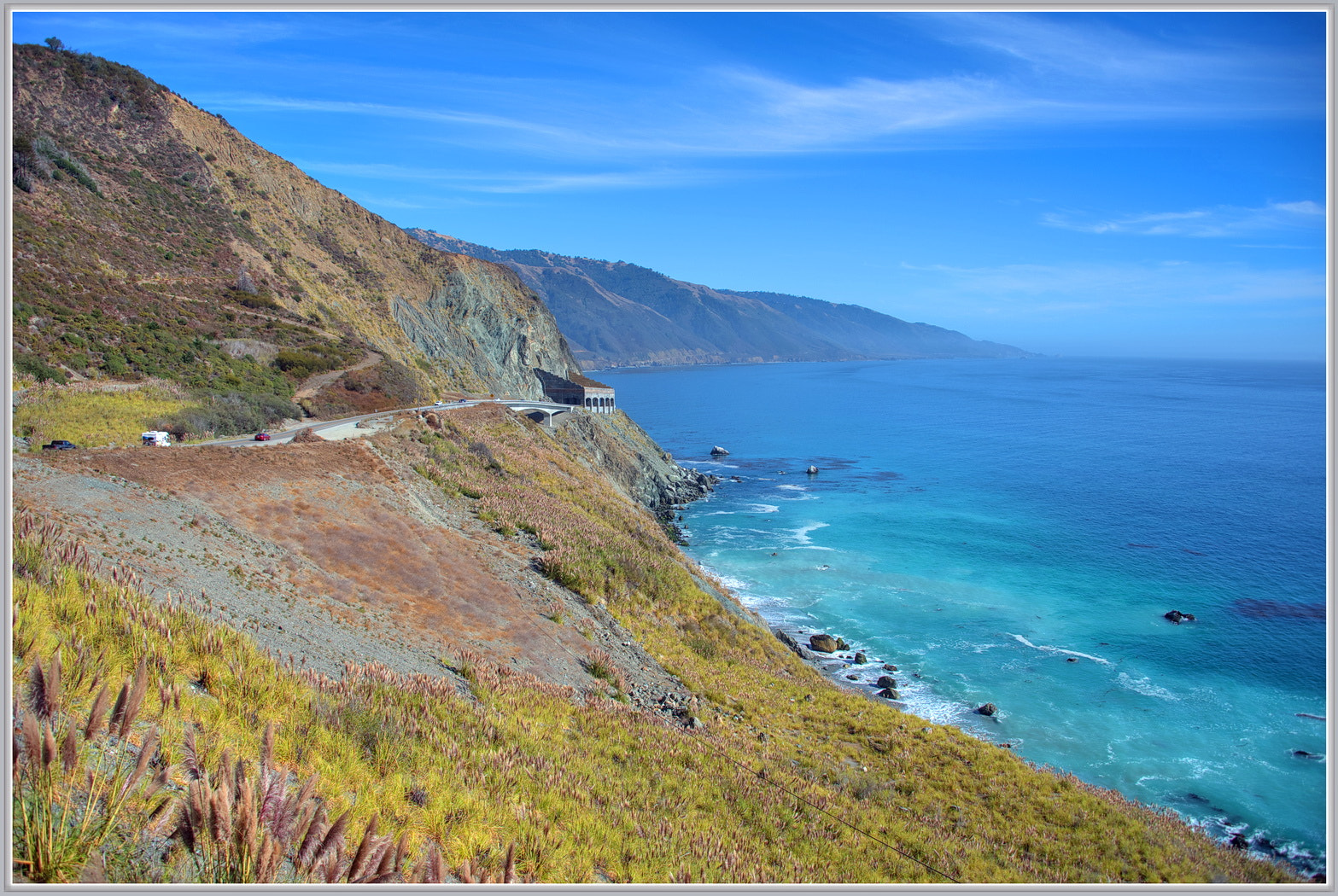 Highway 1 curving along the cliffs of the Big Sur coast with the Pacific below