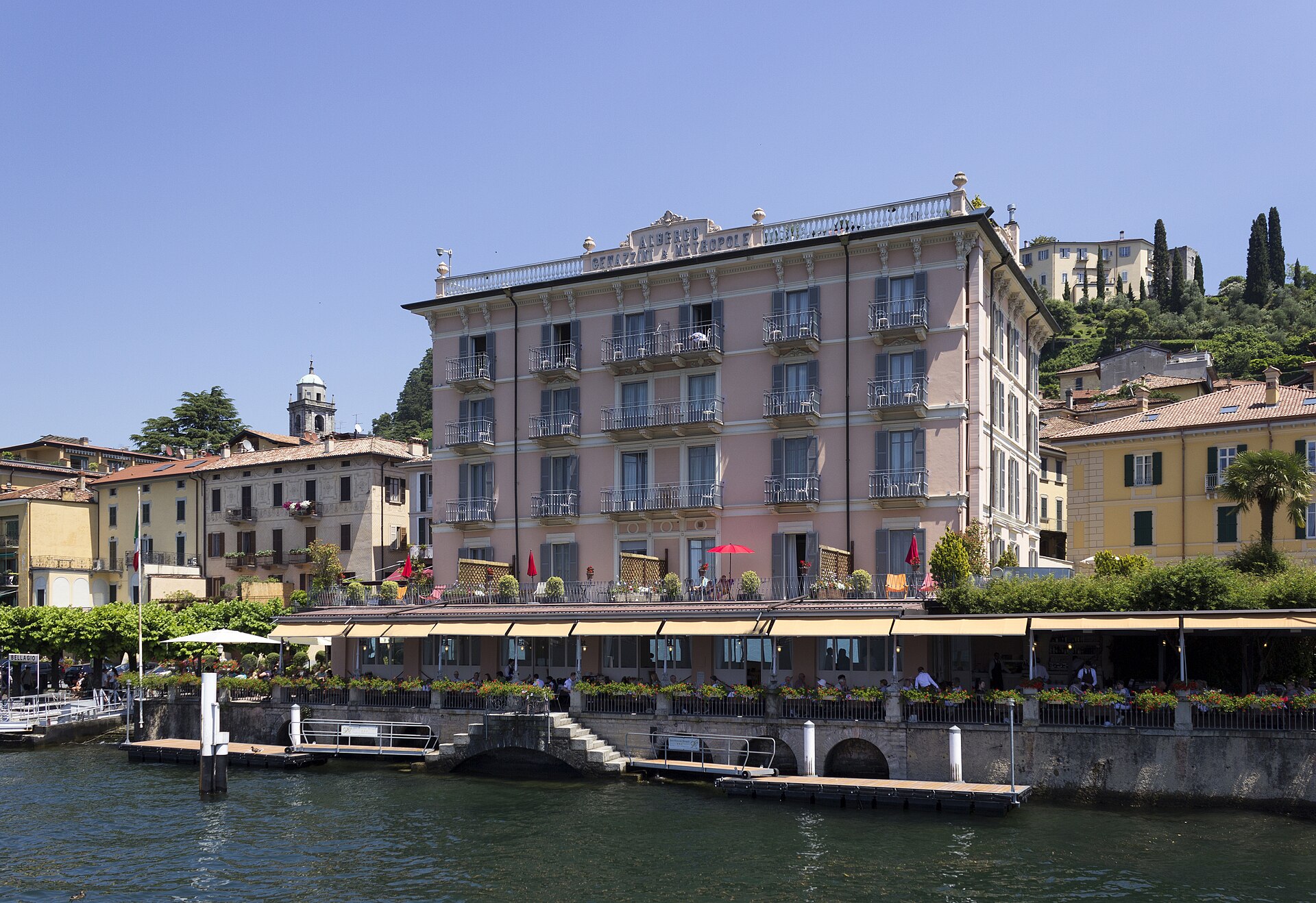 View over Bellagio and the central basin of Lake Como, with steep green mountains rising behind the water where the lake's three arms meet.
