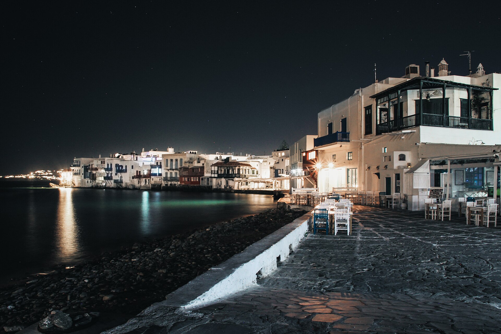 Waterfront houses of Little Venice in Mykonos Town with wooden balconies over the sea at sunset