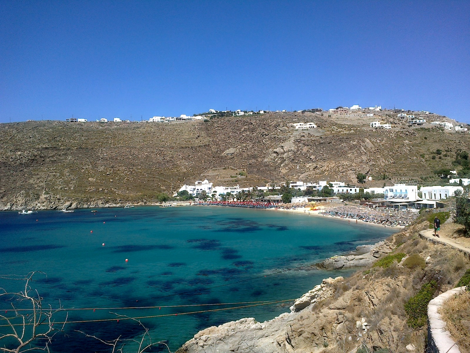 Sunbeds and clear turquoise water at Psarou beach, Mykonos