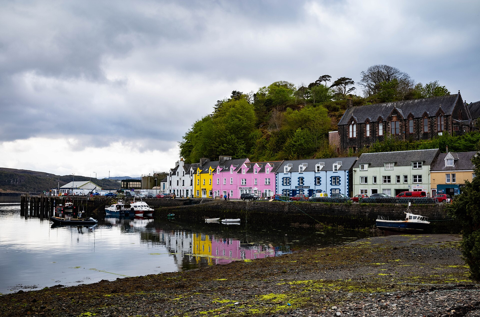 The coloured harbour-front houses of Portree curving around the bay on the Isle of Skye.