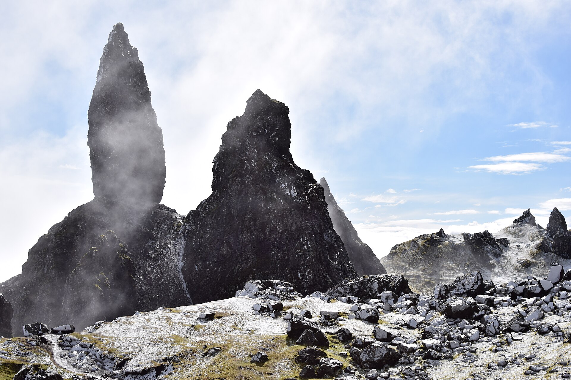 The rock pinnacle of the Old Man of Storr rising above the Trotternish ridge on the Isle of Skye under a clear sky.