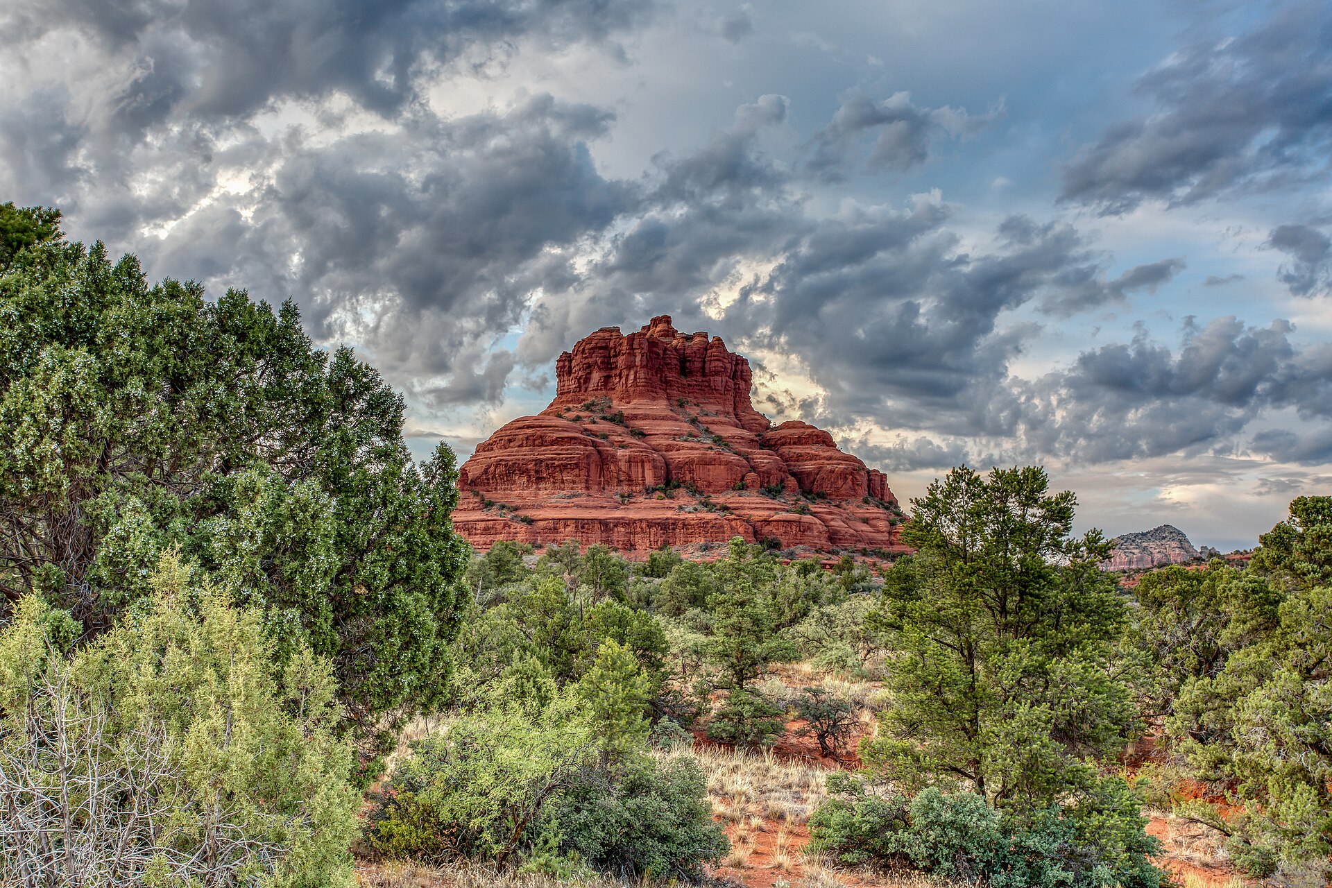 Bell Rock, a rounded red sandstone formation near the Village of Oak Creek south of Sedona, with desert scrub in the foreground.