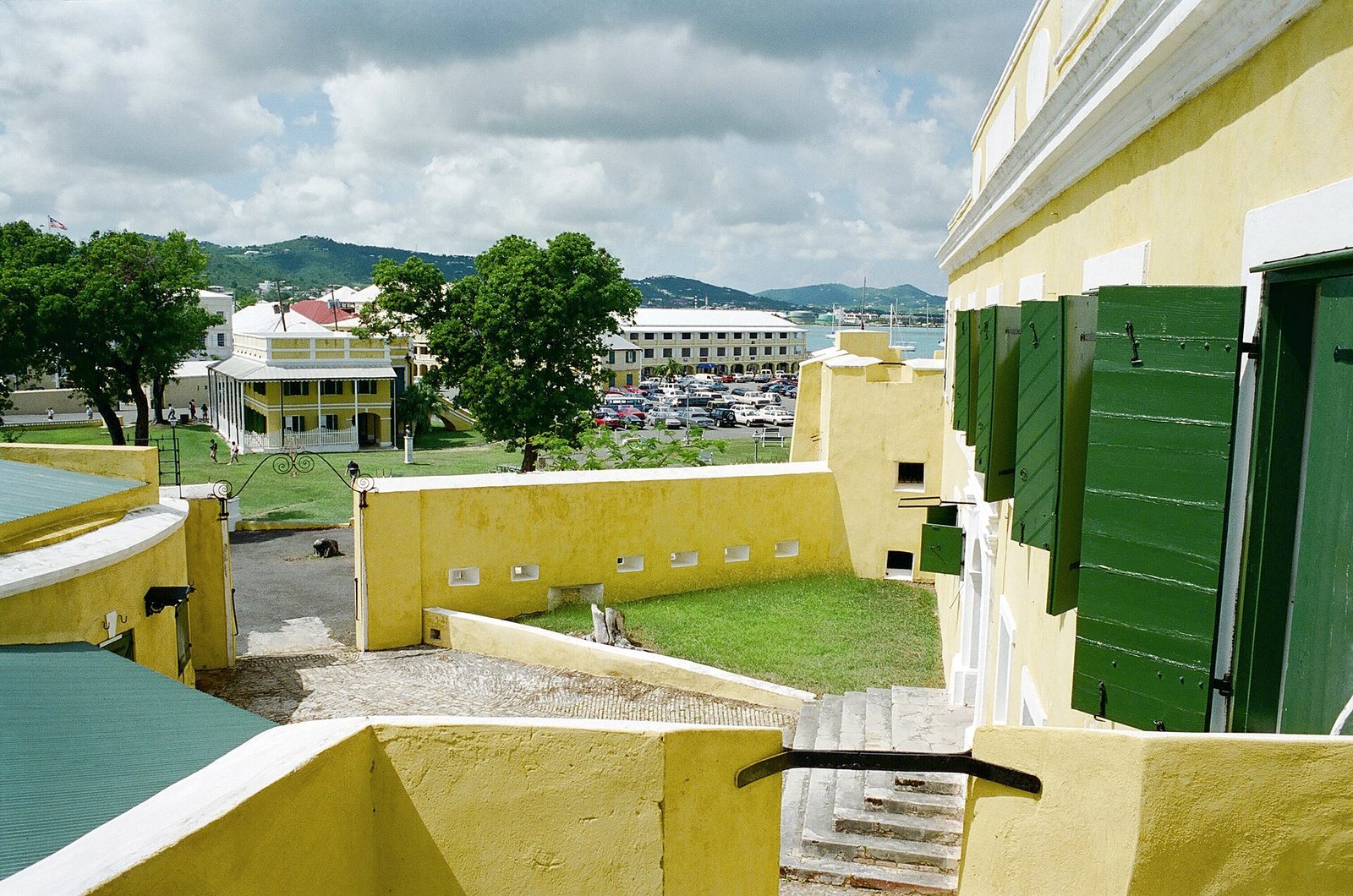 The yellow walls and green shutters of Fort Christiansvaern in Christiansted, looking across the ramparts toward the town.