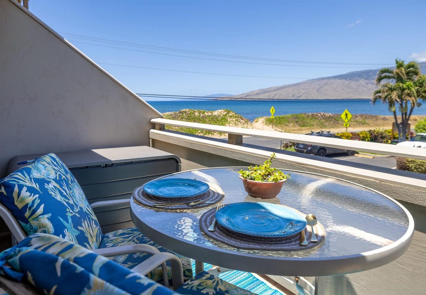 Private lanai at Best Ocean Views set for two, looking across the dunes of Sugar Beach to the ocean and the West Maui Mountains