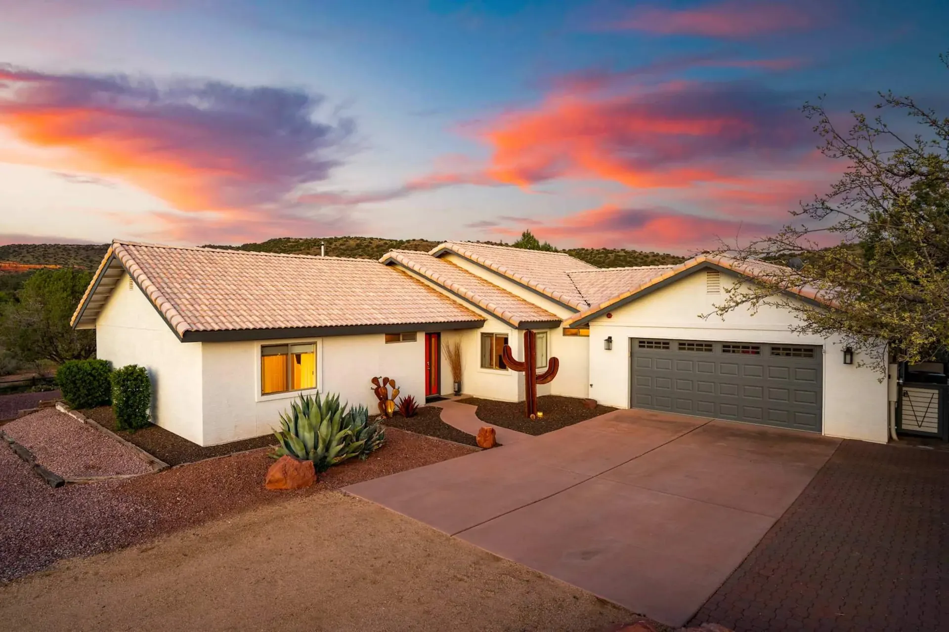 Sedona Pickler, a single-storey stucco home in West Sedona at dusk, with a tiled roof under a pink and blue evening sky