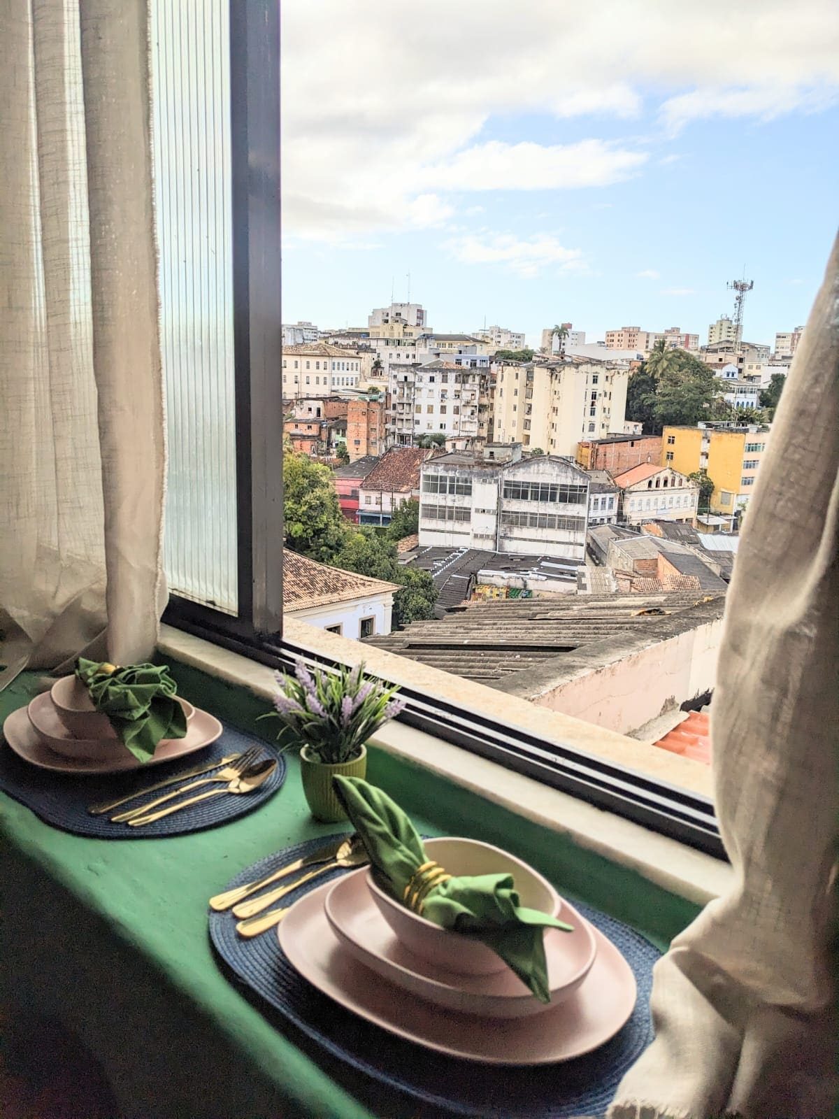 Place setting on the window counter with a view over the rooftops of Salvador in daylight