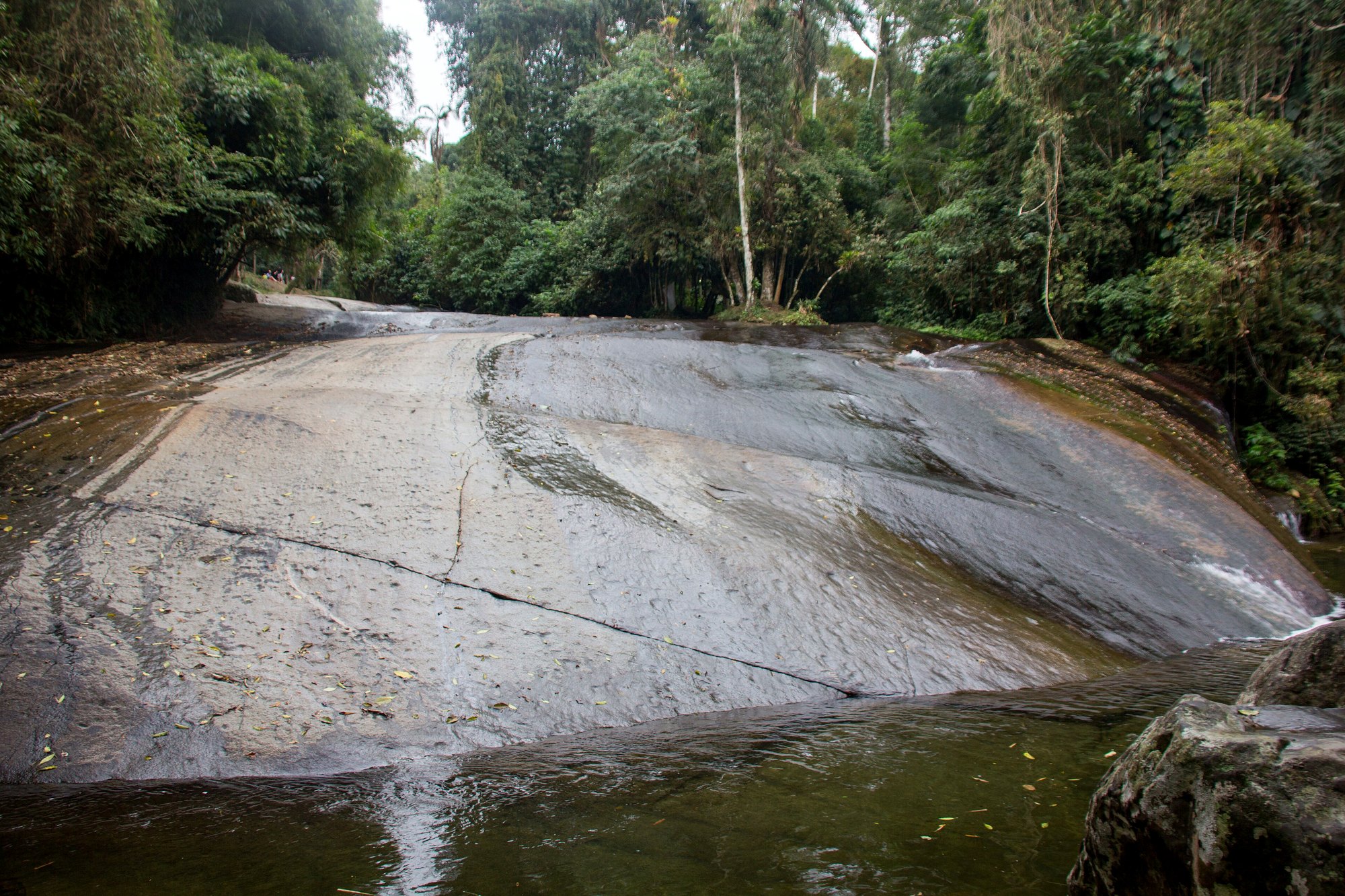 Water rushing down the smooth granite chute of the Cachoeira do Tobogã near Paraty