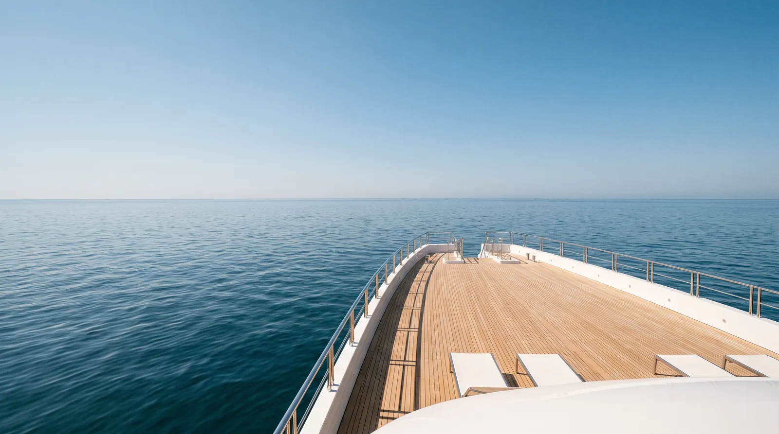 A yacht's stern facing away on a calm ocean.